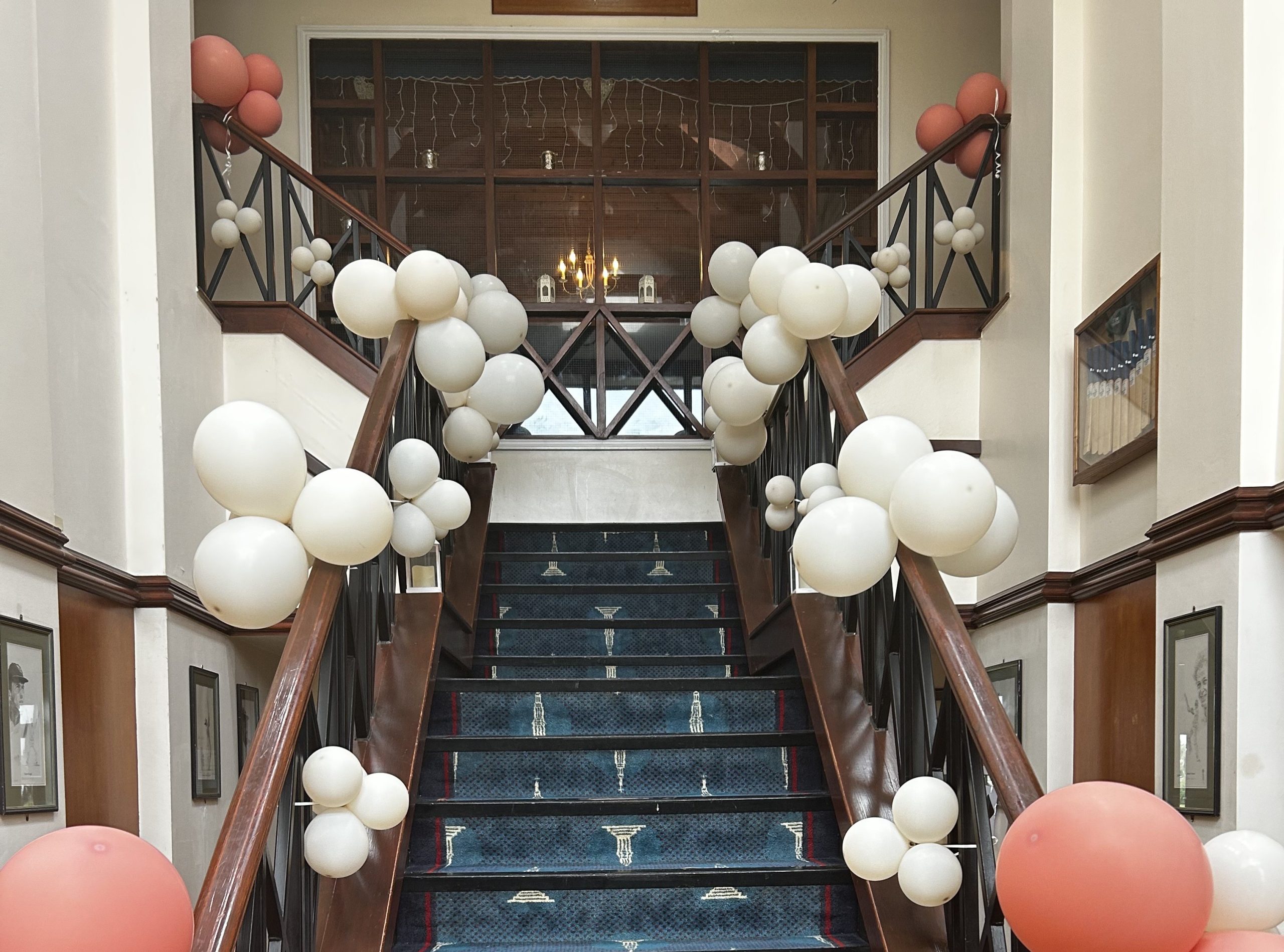 PromStairDecor The stairs at The Pavilion decorated with white and coral balloons