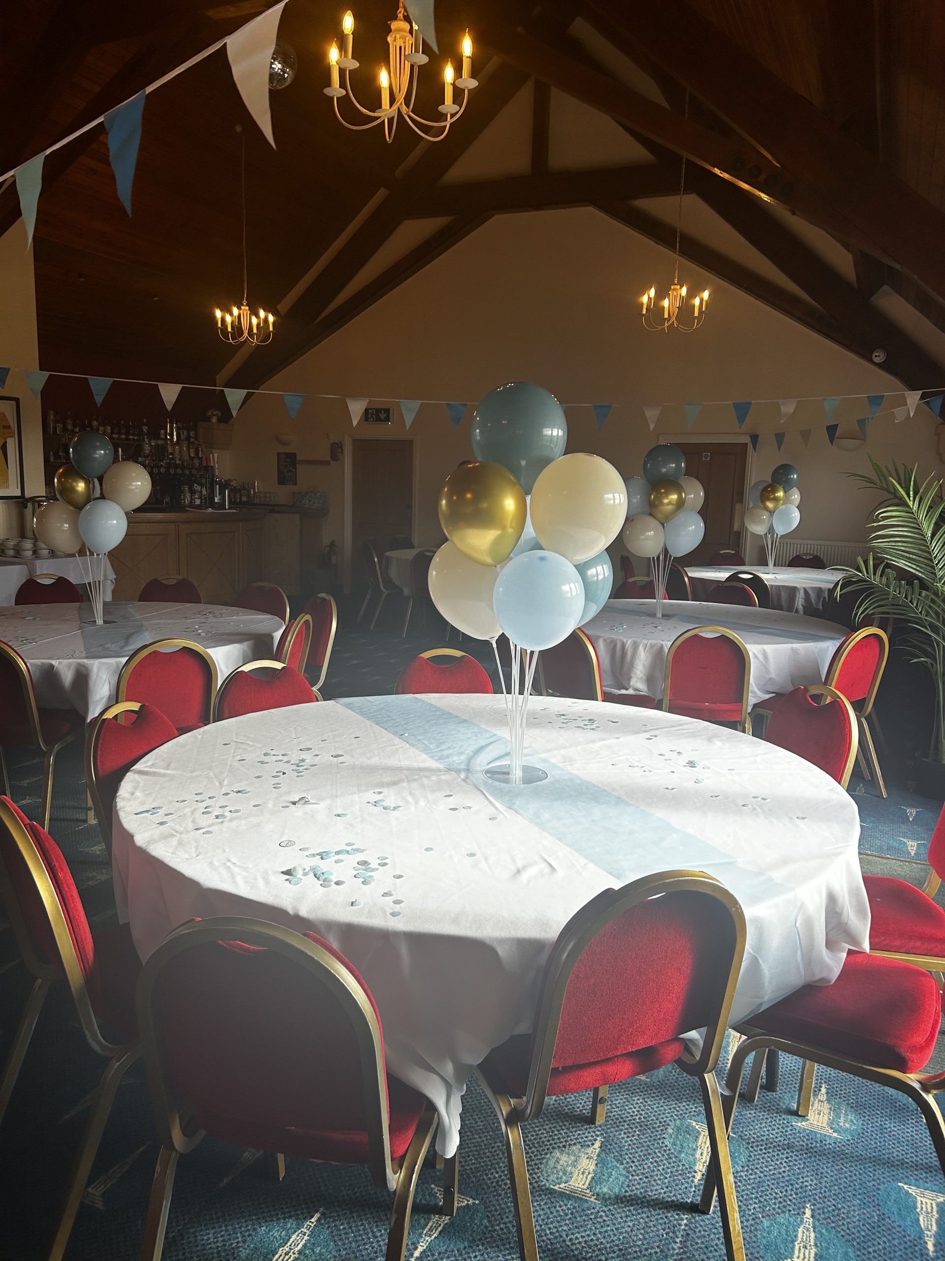 RetirementParty A decorated dining room with white table cloths, banners and balloons